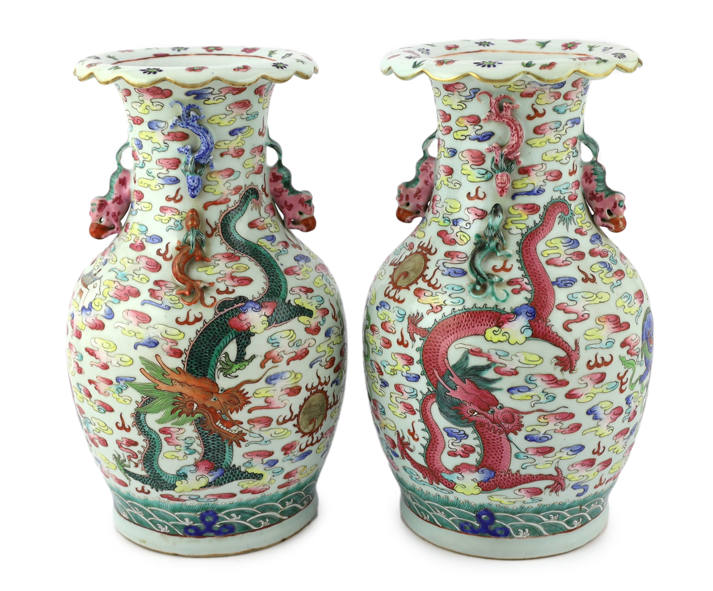 A pair of Chinese enamelled porcelain 'dragon and Buddhist lion' vases, 19th century, body crack to one vase